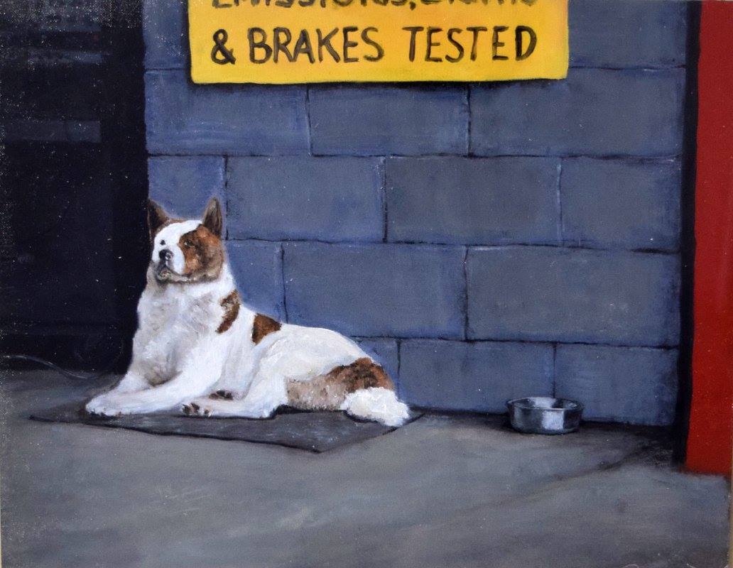 akita dog sitting outside a garage